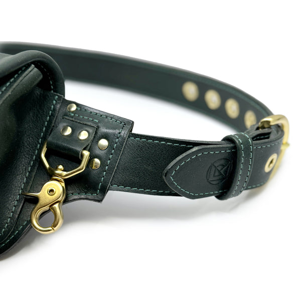 detail of dark greeen leather hip pack brass clip and buckle